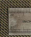 Close-up of brass mesh shielding fabric with a ruler, showing size details. Product: Brass Mesh Shielding Fabric For Industrial Filtration And Signal Screening Non Rustable Woven Wire Metal Mesh 100 By 100 cm Sheet Heavy Duty Versatile All Purpose Mesh Options From 20 To 500.