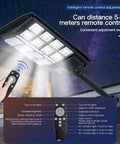 Close-up of 1000W Solar Street Light with 60000 Lumens, 456 LEDs and remote control in use, illuminating a courtyard at night.