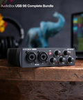 USB Audio Interface 2x2 Bundle With Studio One Pro, front view showing controls on a wooden desk setup for home studio use.