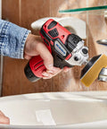 Person using 12V Cordless Mini Polisher and Drill Driver Combo Kit With Three Inch Polisher on bathroom faucet