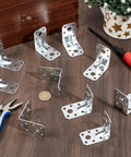 Pack Of Sixty Two By Two Inch Steel L Brackets For Wood Heavy Duty Ninety Degree Angle Corner Braces For Diy Furniture Repair laid out on a wooden table.