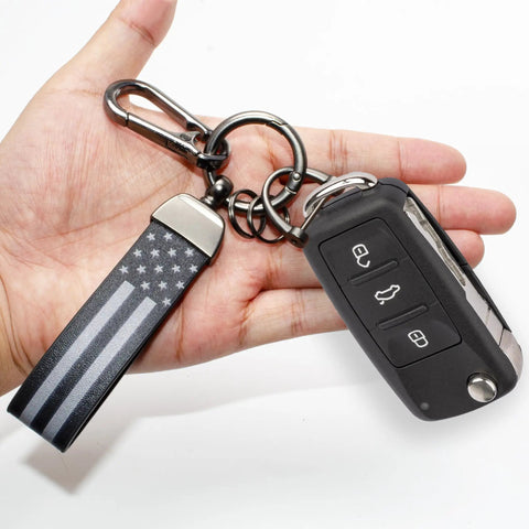 Top Shelf Leather Car Keychain For Men Featuring A Secure Threaded D Ring And Tough Quick Release Loop that shows a car key and strap in hand.