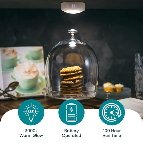 Battery Powered Under Cabinet Lights With Tap Technology illuminating cookies under glass dome on kitchen counter