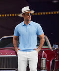 Man in Mens Knit Polo Shirt Short Sleeve Golf Polo With Classic Fit Lightweight Textured Knit Ribbed Hem in light blue, outdoors.