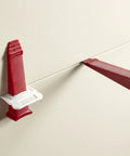 One Eighth Inch T Lock Tile Leveling Kit with clips and wedges in use on tiles for lippage control and grout lines.