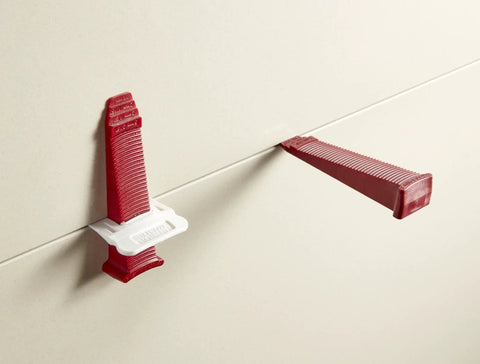 One Eighth Inch T Lock Tile Leveling Kit with clips and wedges in use on tiles for lippage control and grout lines.