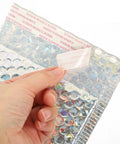 Hand peeling adhesive strip on Silver Bubble Envelope Mailers 15x13cm Pack of 20 Self Seal Padded Shipping Bags, silver finish shown