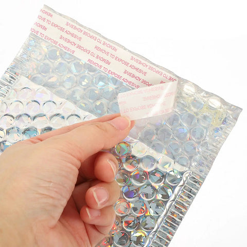 Hand peeling adhesive strip on Silver Bubble Envelope Mailers 15x13cm Pack of 20 Self Seal Padded Shipping Bags, silver finish shown