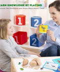 Child and adult using Dig Up Dinosaur Fossil Eggs Kit Break Open Twelve Unique Dino Eggs Uncover Twelve Adorable Dinosaurs Easter STEM Toy For Kids Ages Three To Twelve Hands On Archaeology Science Gift with cards and toy figures.