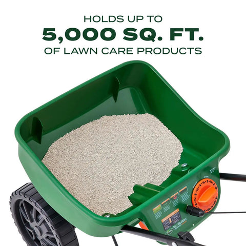 Top view of Turf Builder EdgeGuard Mini Broadcast Spreader For Lawns showing 5,000 sq ft capacity hopper filled with lawn care product