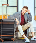 Man sitting with Velaybor lightweight 3 piece luggage set with spinner wheels, 20 inch black carry-on, durable hardside PC case.