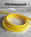 Outdoor 50 Feet Heavy Duty 10 Gauge Extension Cord With Lighted End, waterproof, coiled in rain showing IP65 weather-resistant feature