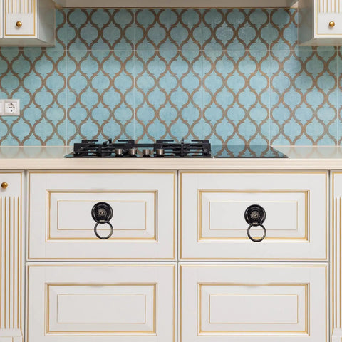 Kitchen cabinets with vintage hardware and blue patterned backsplash