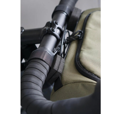 Close-up of Everywhere Handlebar Bag 5L Rigid Front Barrel Pack With Foam Spacer Kit attached to bike handlebars.
