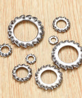 Stainless steel external-tooth star lock washers in assorted sizes, flat lay view