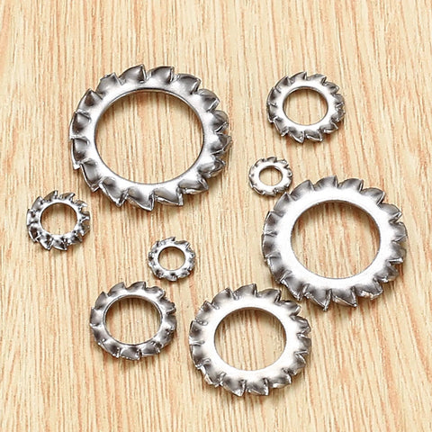 Stainless steel external-tooth star lock washers in assorted sizes, flat lay view