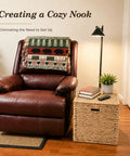 Handwoven Water Hyacinth Storage Trunk With Lid And Handles next to leather armchair, rustic wicker storage chest with books