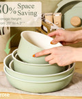 Stacked bowls from Detachable Handle Nonstick Cookware Set 19 Piece Induction Compatible Pots And Pans Oven Safe in Sage Green