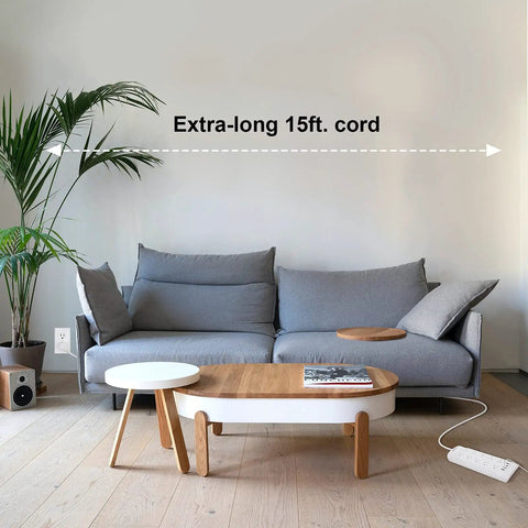 15 Foot Power Strip Surge Protector with Ten Widely Spaced Outlets Flat Low Profile Plug next to a sofa in a living room