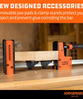 Close-up of 36 Inch Parallel Bar Clamp Set 2200 Lb Beefy Heavy Duty Cabinet Master in use on a wooden board in a workshop setting.