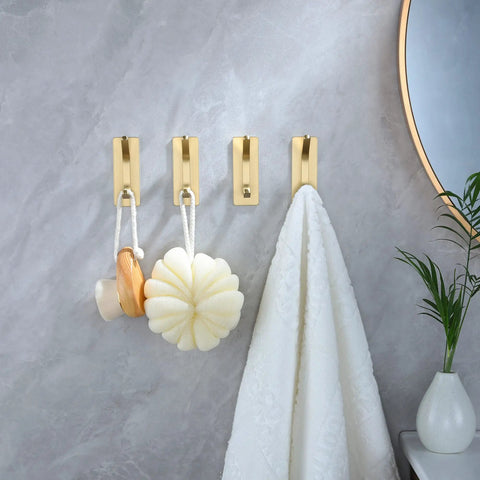 Brushed Gold Self Adhesive Wall Hooks Four Pack Stainless Steel Towel Coat Hat Robe Hangers For Bathroom And Kitchen No Drill Easy Install Rustproof Strong Hold In Wet Environments mounted on a bathroom wall