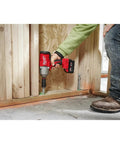 Person using Half Inch Brushless Impact Wrench With RedLink Intelligence High Torque Beast For Tough Fasteners Delivers Eight Hundred Foot Pounds Fastening Torque And One Thousand Two Hundred Foot Pounds Nut Busting Torque 18V M18 System Friction Ring Anvil on wooden frame