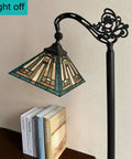 Tiffany Style Reading Floor Lamp With Stained Glass Shade Gooseneck Tall Standing Lamp in living room with books on table, light off.