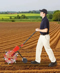 Man using Hand Push Manual Seeder With 6 Nozzle Row Crop Planter, 8.27Lb Seed Capacity in field, durable iron and plastic construction