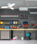 LED Garage Light With Multiple Adjustable Panels, E26 Base, 4,000 Lumens, ceiling-mounted in a workshop with shelves and tools
