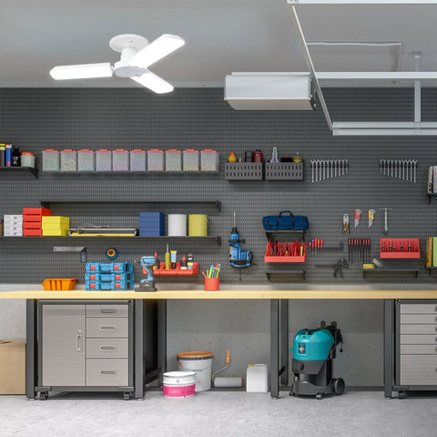LED Garage Light With Multiple Adjustable Panels, E26 Base, 4,000 Lumens, ceiling-mounted in a workshop with shelves and tools