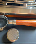 Bottomless 51mm Portafilter For DeLonghi Espresso Machines Stainless Steel Two Ear Handle displayed on coffee machine