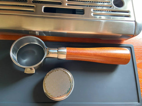 Bottomless 51mm Portafilter For DeLonghi Espresso Machines Stainless Steel Two Ear Handle displayed on coffee machine