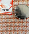 Copper Mesh Screen 100 Mesh 1x1m for EMF Shielding and Impurity Filtration, close-up of copper grid with label and round disk.