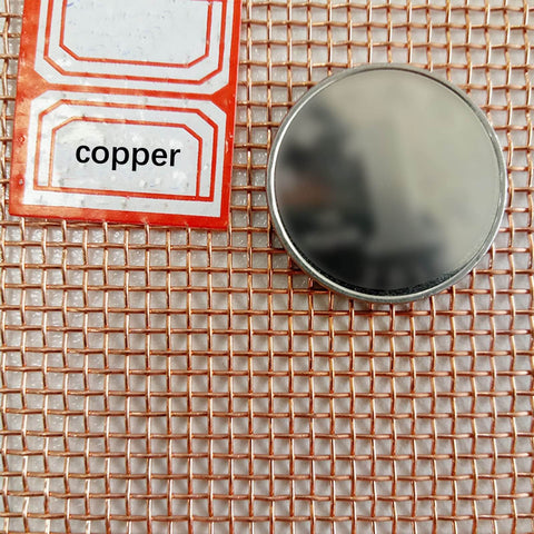 Copper Mesh Screen 100 Mesh 1x1m for EMF Shielding and Impurity Filtration, close-up of copper grid with label and round disk.