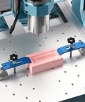 2 Piece Clamp Block Set with 8 Adjustable Stops for CNC Router Workholding in action on a metal CNC table with pink block.