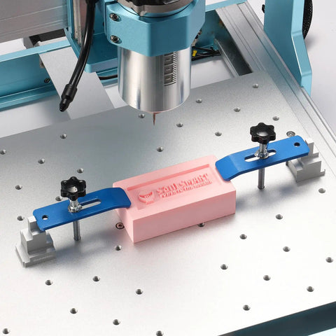 2 Piece Clamp Block Set with 8 Adjustable Stops for CNC Router Workholding in action on a metal CNC table with pink block.