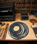 20 Pack Black Round Cassette Recorder Belts 1.5mm Thick Replacement Belts For Tape Decks And Cassette Players on a workbench