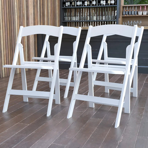 Hercules Series White Padded Folding Chair Set Of 4 Ultra Lightweight Event Seating With 800 Lb Capacity in wood-floored venue