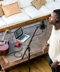 Home studio setup with Scarlett Solo 3rd Gen USB Audio Interface Bundle and LyxPro mic in use, guitar and laptop on wooden table