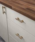 Champagne Bronze Cabinet Hardware Set 5 Pack Adjustable Drawer Pulls installed on white kitchen cabinets with wood countertop