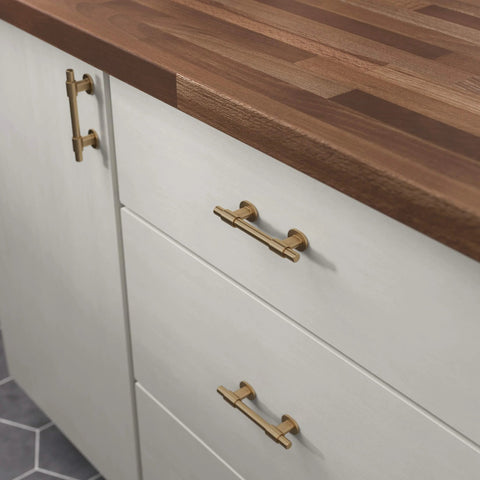 Champagne Bronze Cabinet Hardware Set 5 Pack Adjustable Drawer Pulls installed on white kitchen cabinets with wood countertop