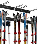 Wall Mounted Ski Rack With Extra Boot Hooks, Garage Game Changer Holds Eight Pair Skis displaying six pairs of skis and accessories.