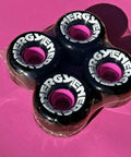 Energy 65 Quad Roller Skate Wheels Set For Outdoor Rolling, 78A Urethane, 35mm X 65mm, 4 Pack In Black on pink background