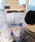 Technician using 24 Inch Wide Portable Laminar Flow Hood for Medical and Laboratory Use, ISO Class 5 Cleanroom, Vertical Laminar Flow