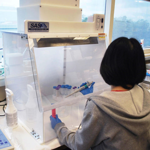 Technician using 24 Inch Wide Portable Laminar Flow Hood for Medical and Laboratory Use, ISO Class 5 Cleanroom, Vertical Laminar Flow