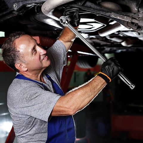 A mechanic using the Smooth As Butter Extra Long Handle 1/2 Inch Drive 90 Tooth Ratchet Wrench for auto repair.