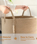 Person holding a Boho Jute Laundry Hamper Basket With Handles Tall Wicker Hamper for Nursery and Laundry Room, 16 by 20 inches
