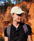 Yacht Vibes No Crying On The Yacht Inspired Cotton Baseball Cap for men, cream color, worn outdoors, showing side view with sunlight.