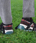 Pre Assembled Lawn Aerator Shoes with spiked metal grips, adjustable straps for men and women on grass.