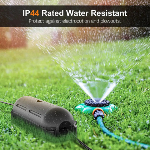 Two Pack Waterproof Outdoor Extension Cord Cover protecting electrical connection from sprinkler on grass